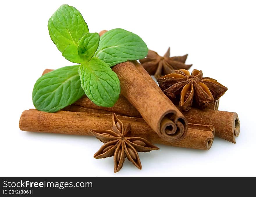 Sticks of cinnamon with mint and anise on a white background. Sticks of cinnamon with mint and anise on a white background