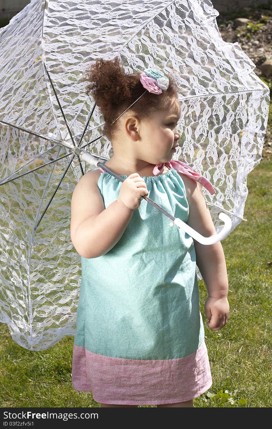 Young girl holding an umbrella during spring time