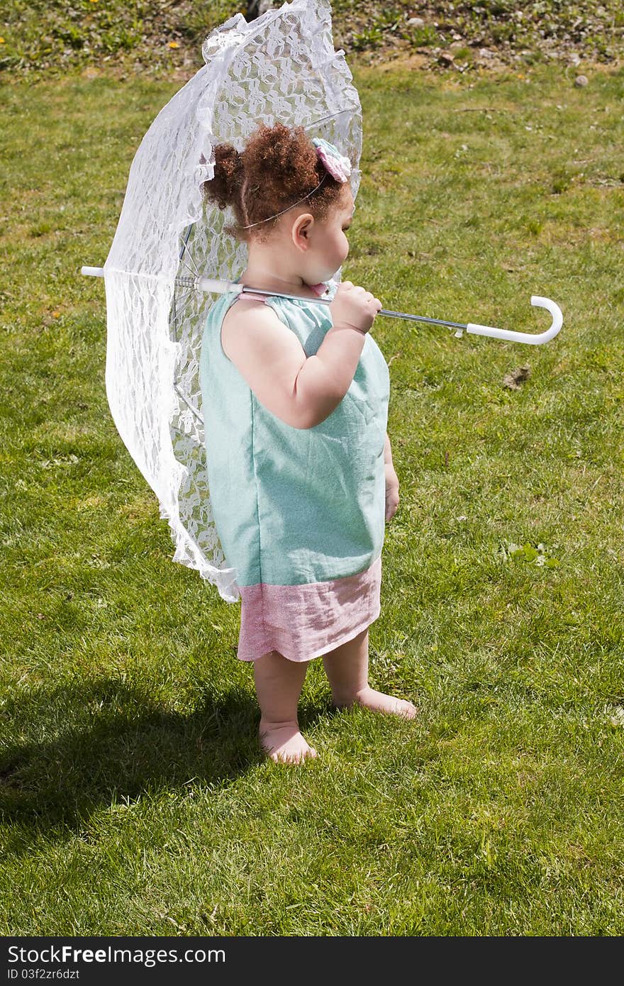 Young girl holding an umbrella during spring time