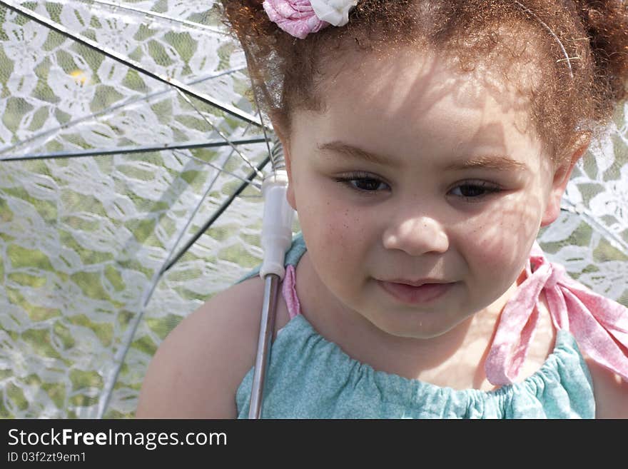 Young girl holding an umbrella during spring time