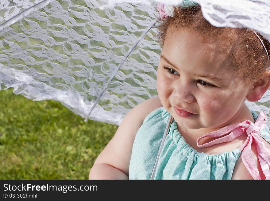 Young girl holding an umbrella during spring time