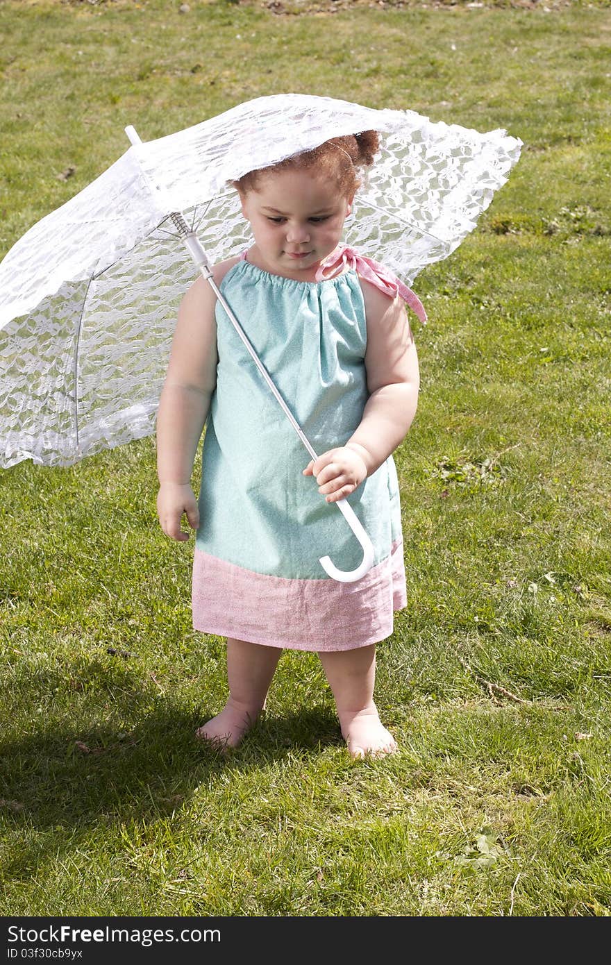 Young girl holding an umbrella during spring time