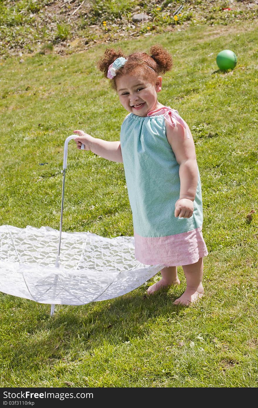 Young girl holding an umbrella during spring time