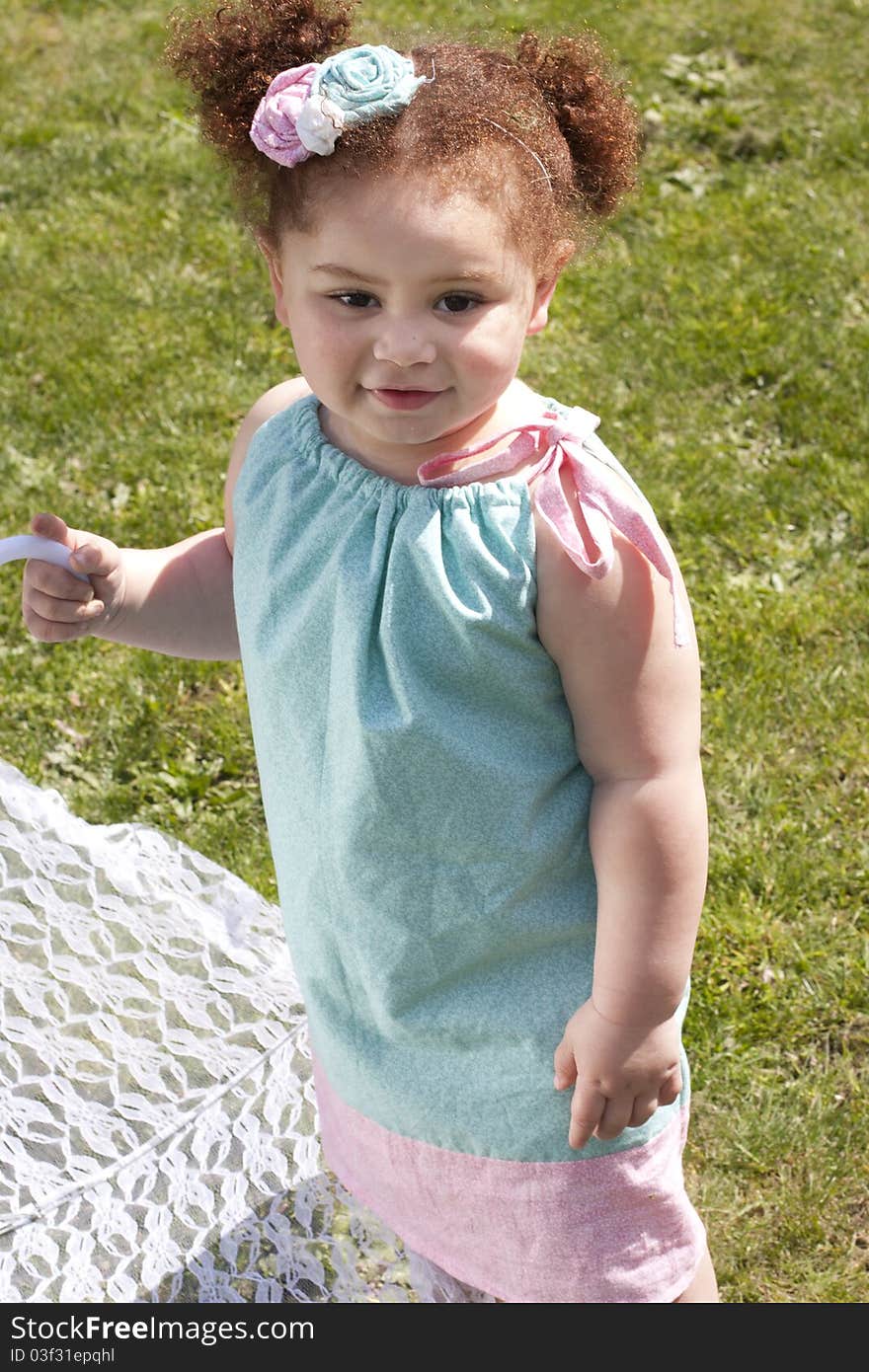 Young girl holding an umbrella during spring time