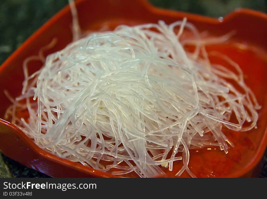 Raw vermicelli set on red plate ready to cooking. Raw vermicelli set on red plate ready to cooking