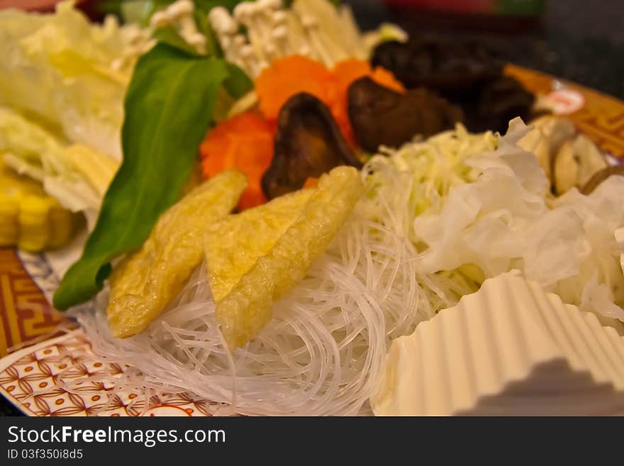 Various vegetables in set on dish included mushroom, canton, morning glory, carrot, cabbage, etc. tilted left. Various vegetables in set on dish included mushroom, canton, morning glory, carrot, cabbage, etc. tilted left