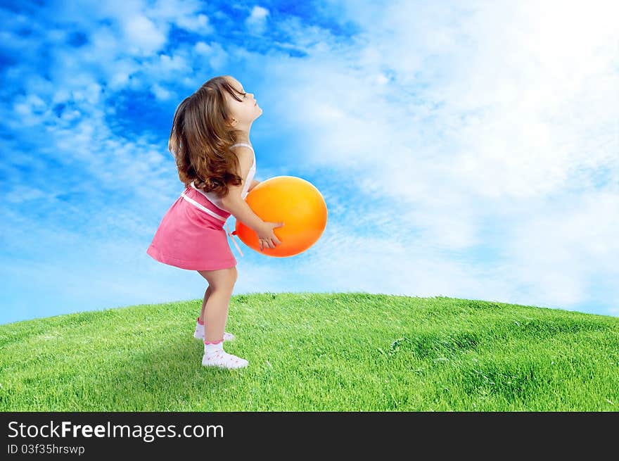 Little Girl Plays With ellow Balloon In Grass