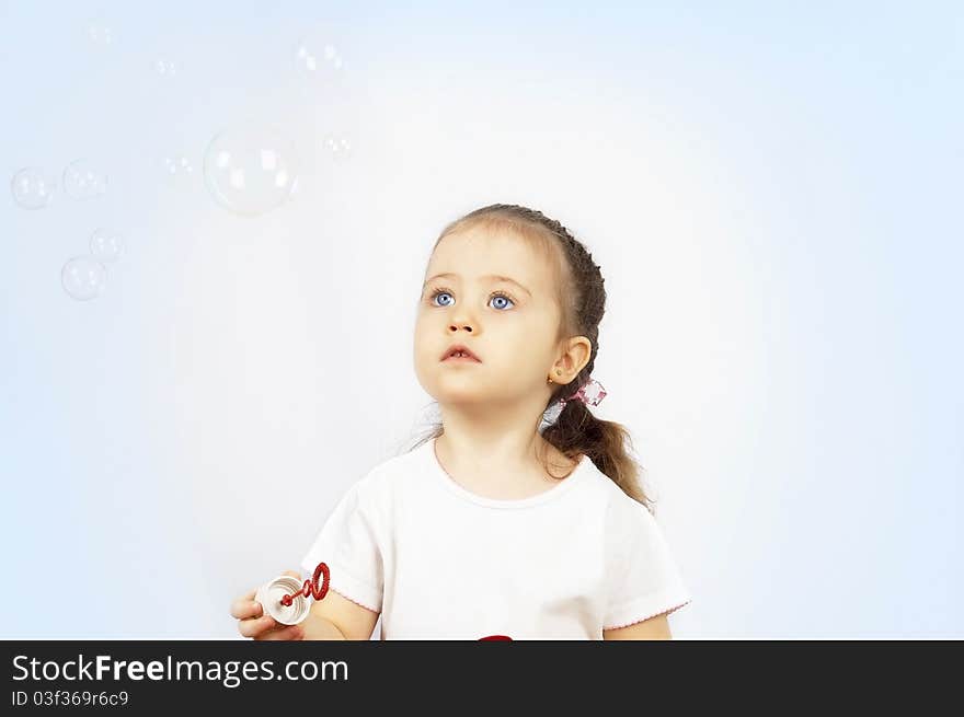 The girl starting up soap bubbles.isolated