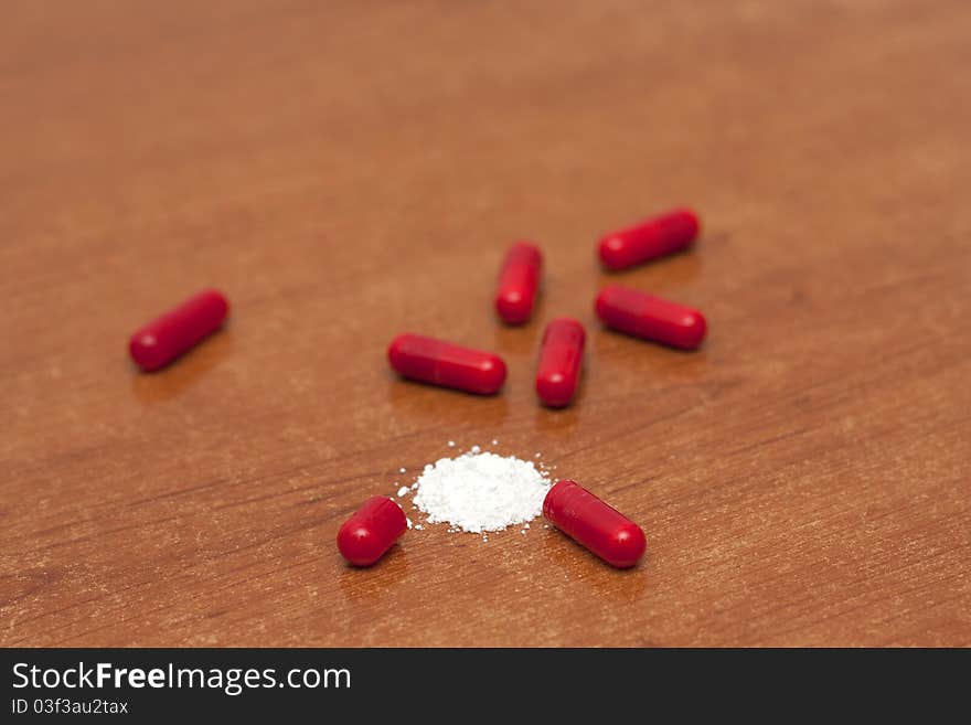 One tablet of red capsules; Narcotics standin in a table. One tablet of red capsules; Narcotics standin in a table