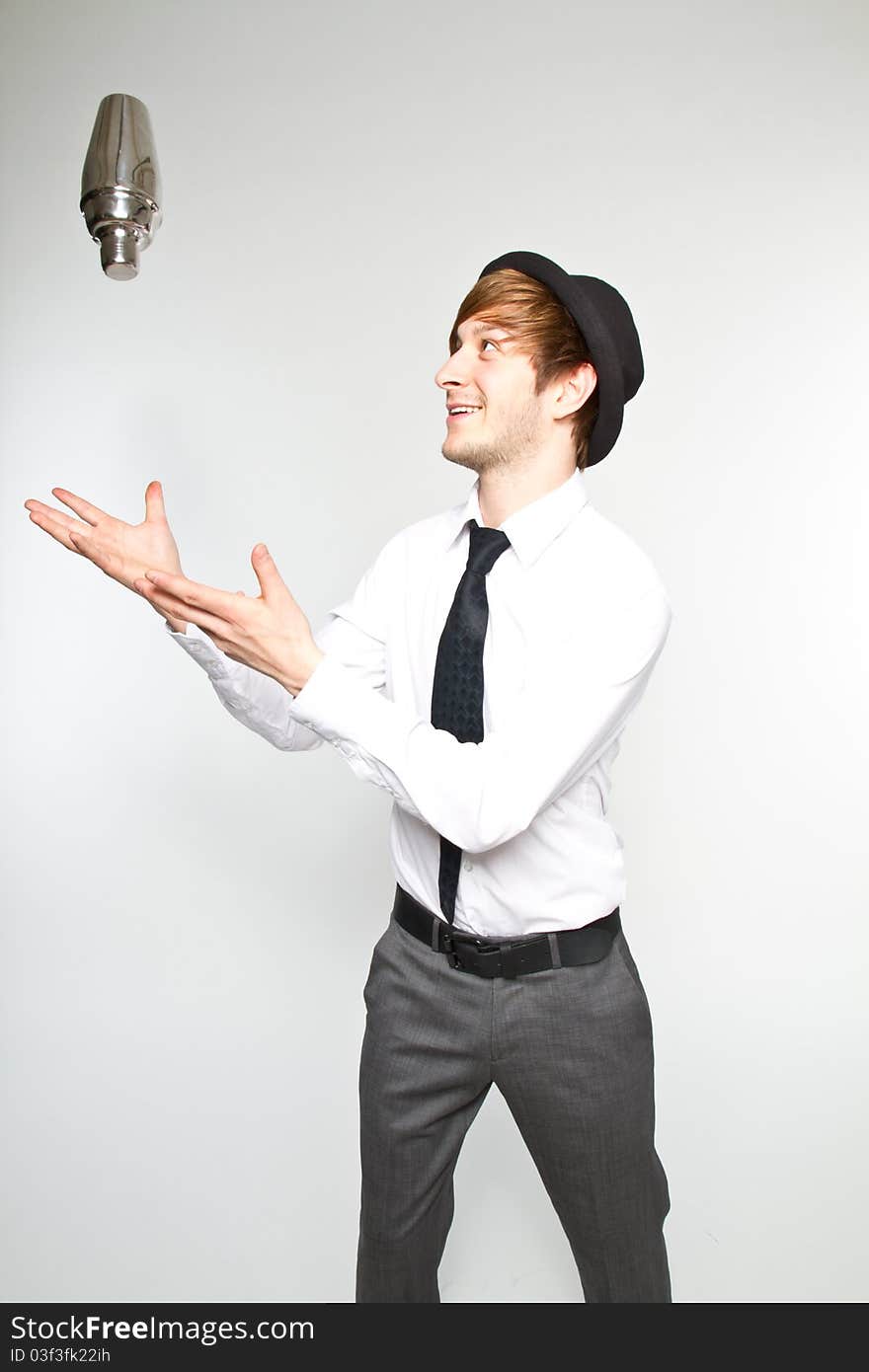 Young barkeeper shaking fresh cocktails. Young barkeeper shaking fresh cocktails