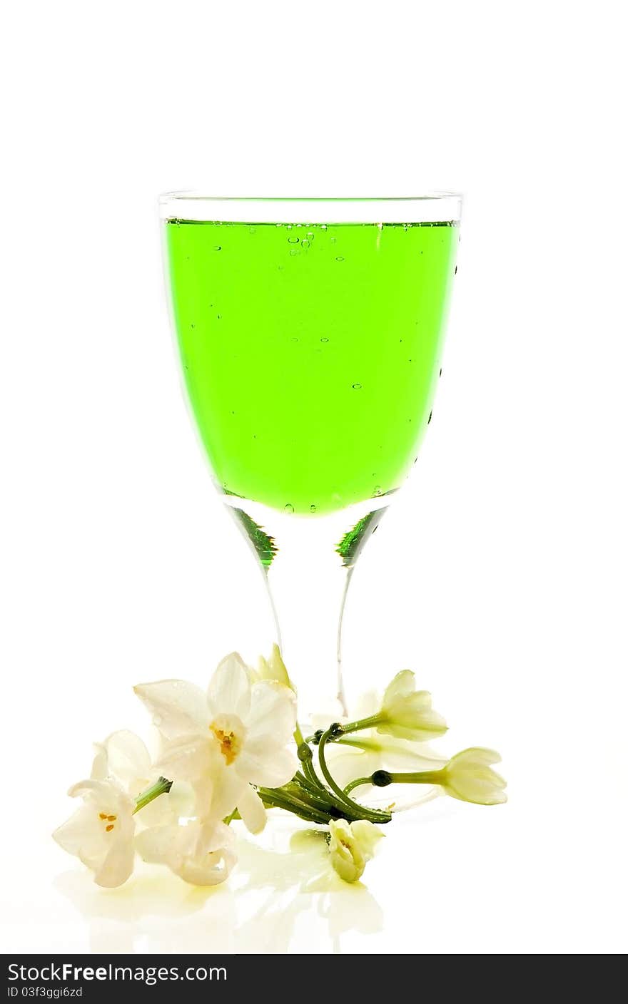 Lemonade of green color in a glass bottle on the white isolated background. Lemonade of green color in a glass bottle on the white isolated background