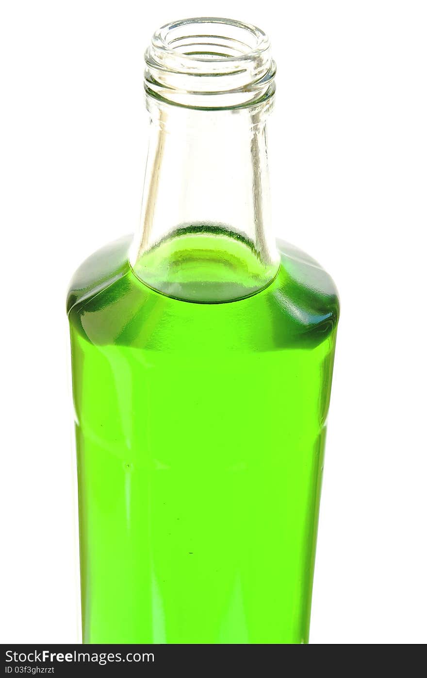 Lemonade of green color in a glass bottle on the white isolated background