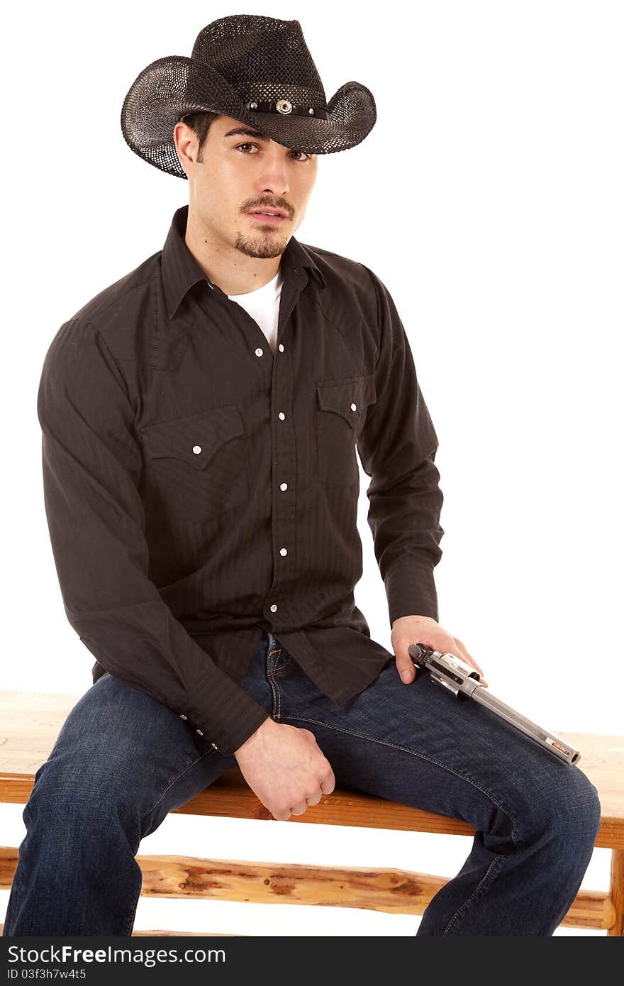 Cowboy sitting with gun on leg