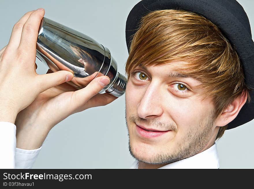 Young barkeeper shaking fresh cocktails. Young barkeeper shaking fresh cocktails