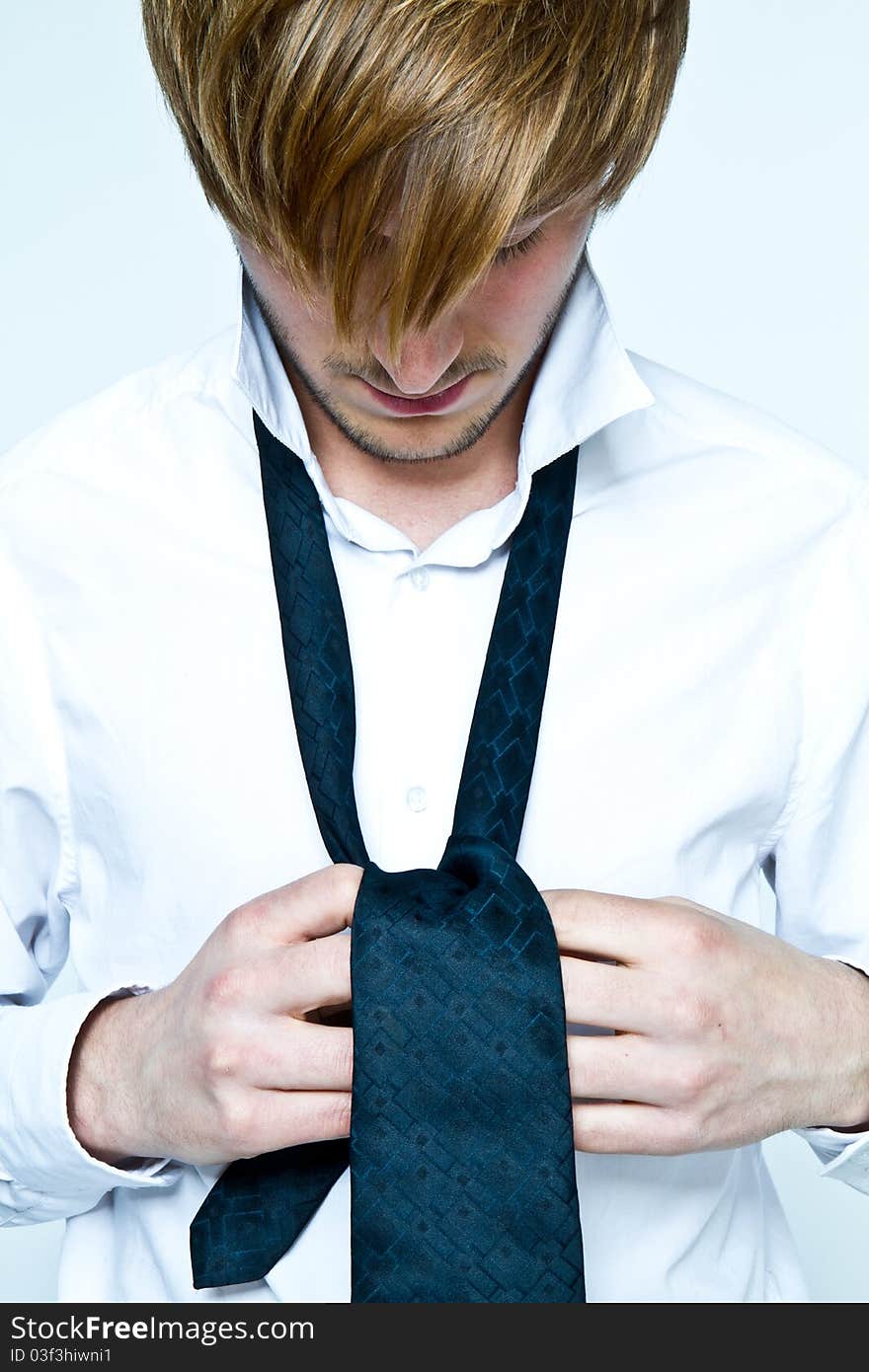 Young man is dressing up with tie. Young man is dressing up with tie