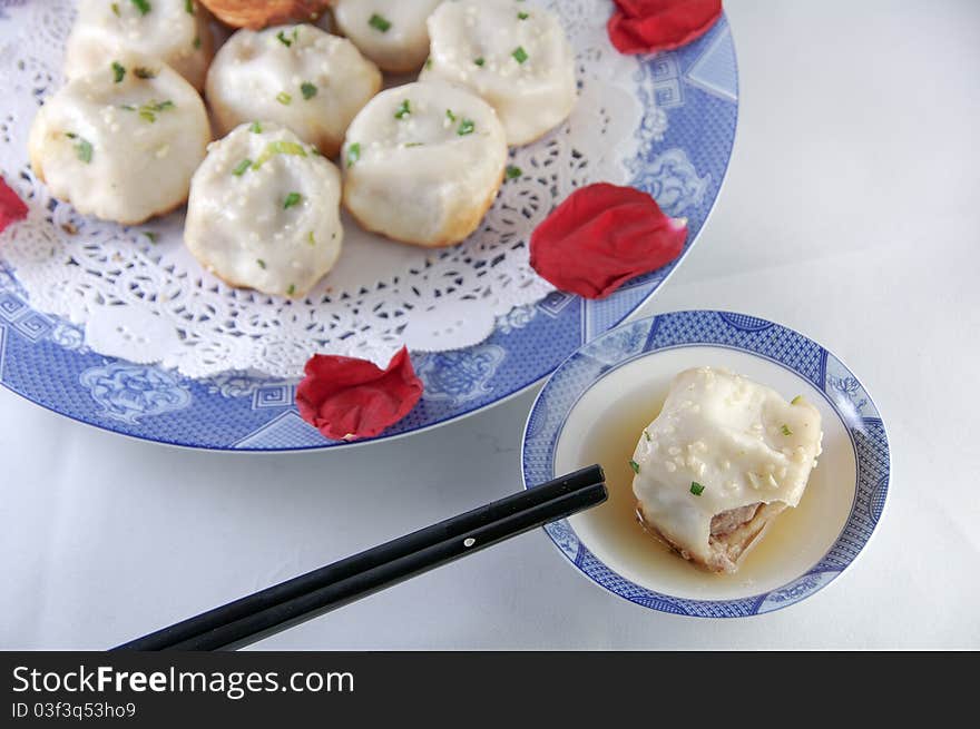 Chinese characteristic fried bun on a porcelain plate. Chinese characteristic fried bun on a porcelain plate