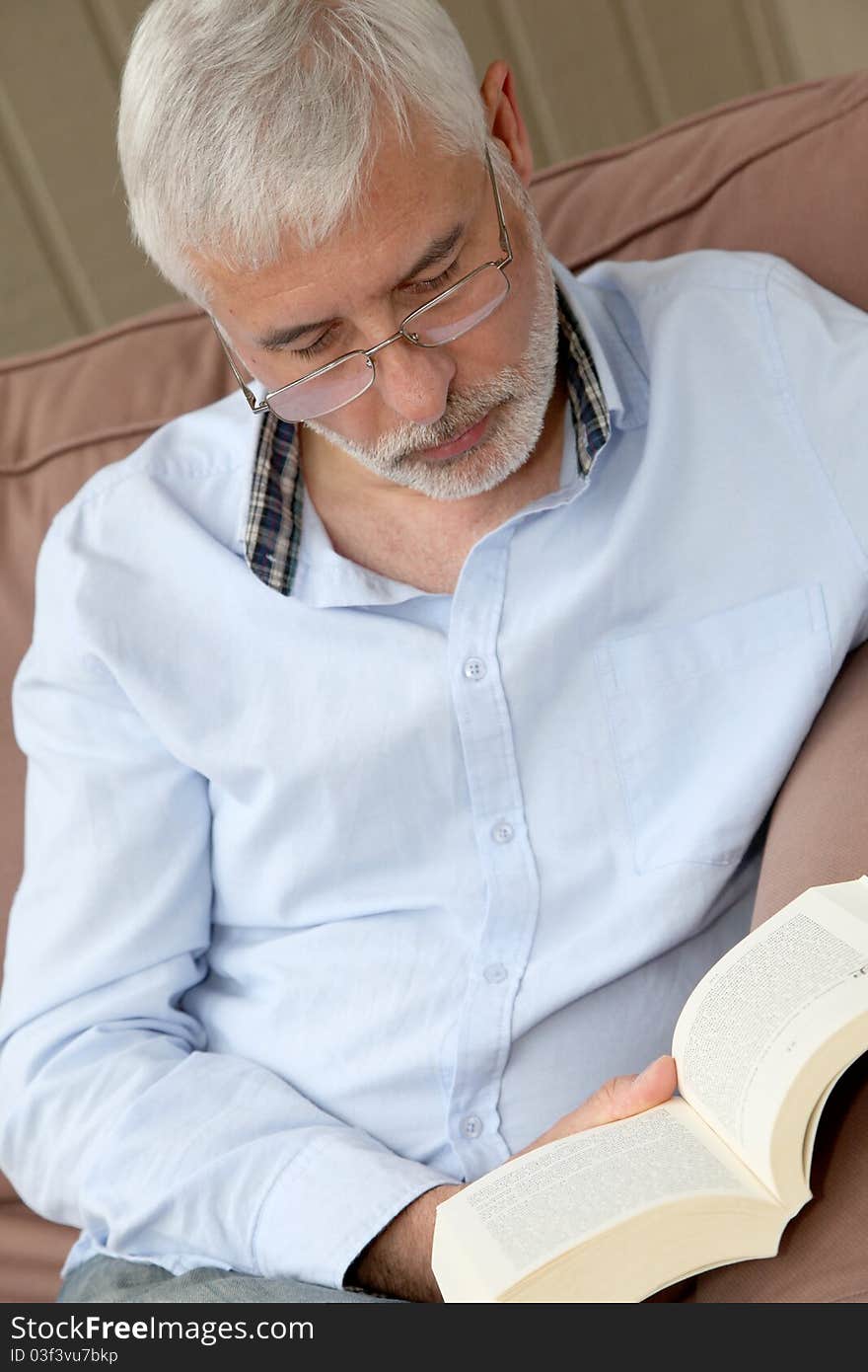 Portrait of senior man reading a book. Portrait of senior man reading a book