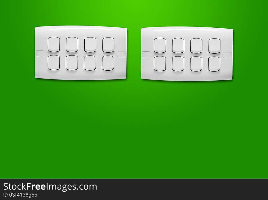 White light switch against a green wall. White light switch against a green wall.