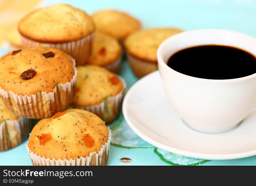 Freshly baked muffins and a white coffee cup. Freshly baked muffins and a white coffee cup