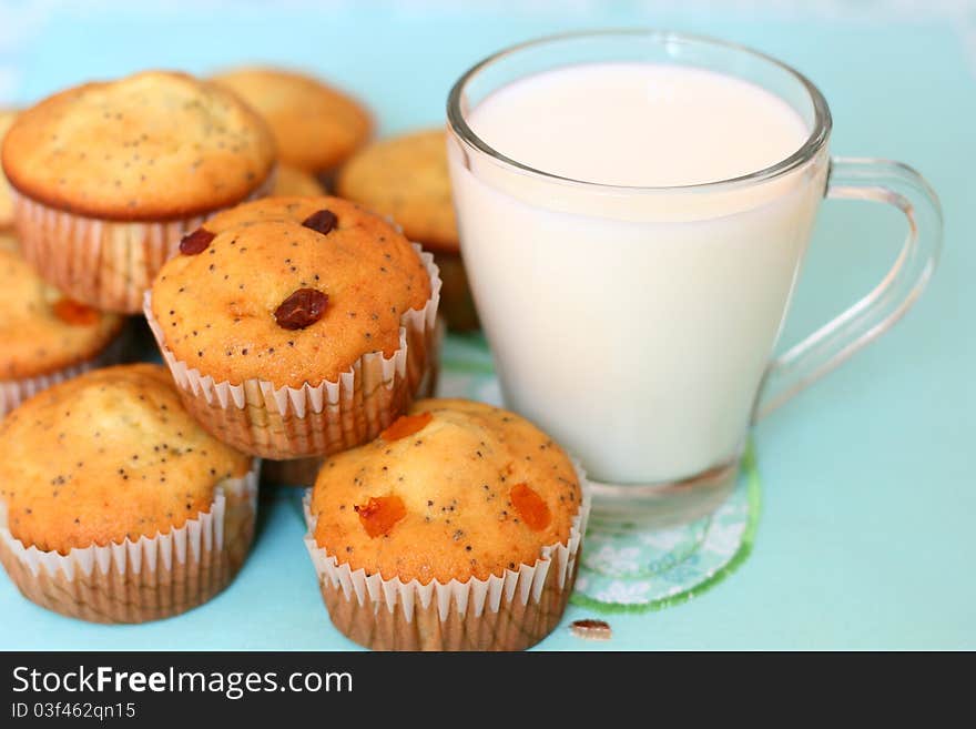 Cup cakes stacked near a glass of fresh milk. Cup cakes stacked near a glass of fresh milk