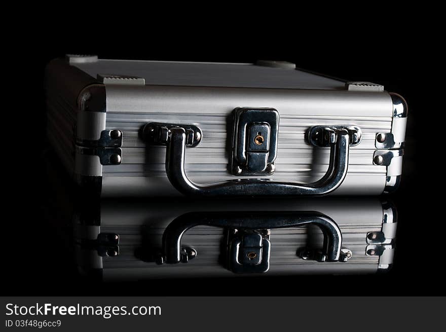 Black suitcase isolated on a black background