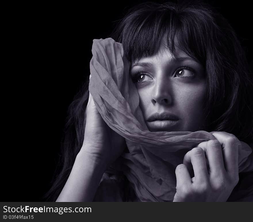 Beautiful young woman holding a shawl to her face. Beautiful young woman holding a shawl to her face.