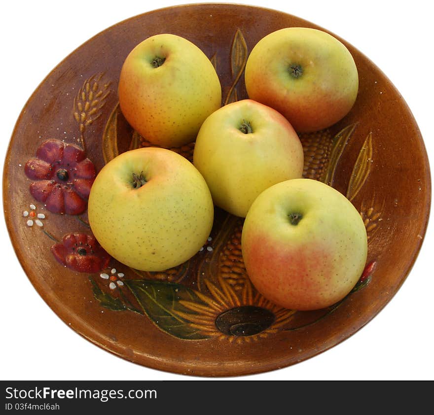 Natural apples on a ceramic, painted plate. Isolated on white background. Natural apples on a ceramic, painted plate. Isolated on white background.