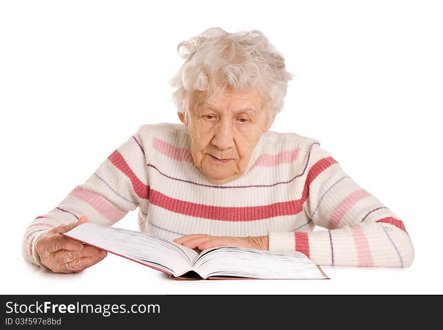 The elderly woman reads the book isolated