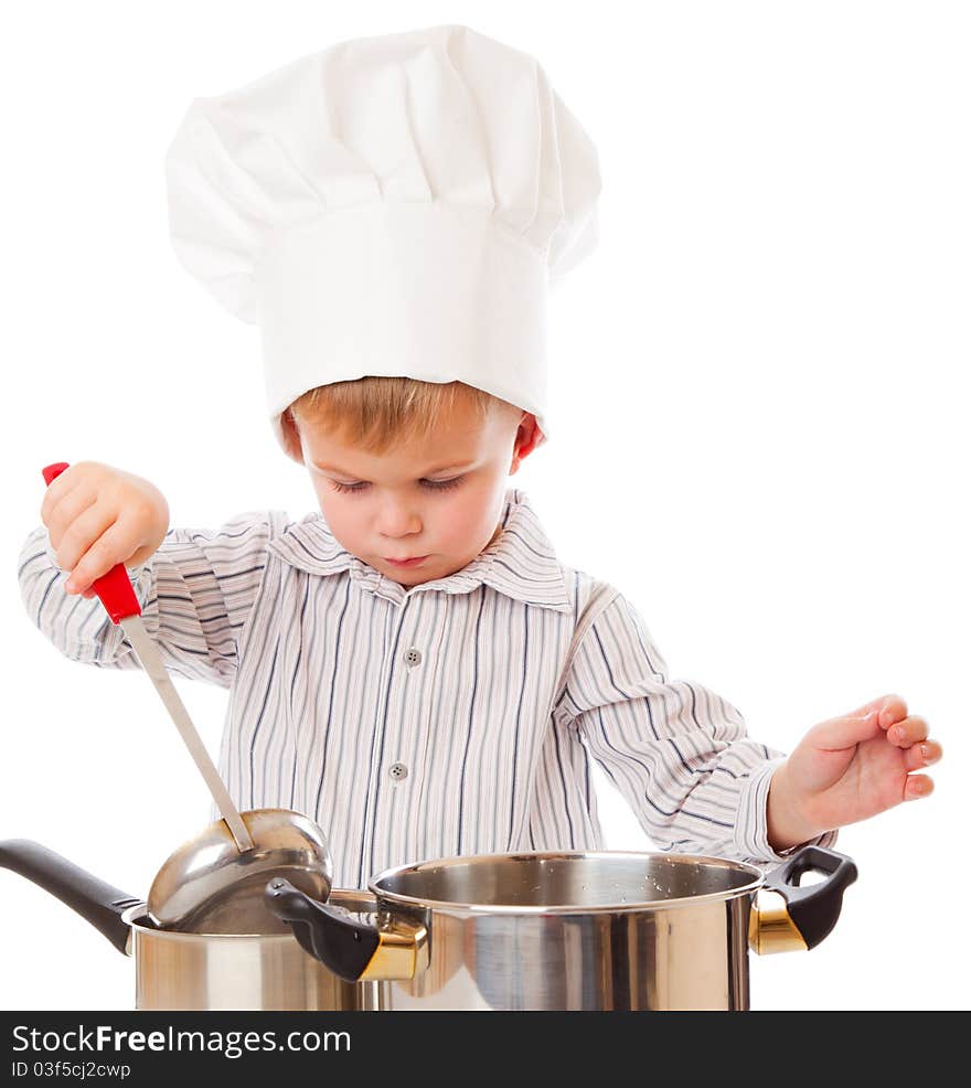 A funny cute boy is portraying a cook. isolated on a white background. A funny cute boy is portraying a cook. isolated on a white background