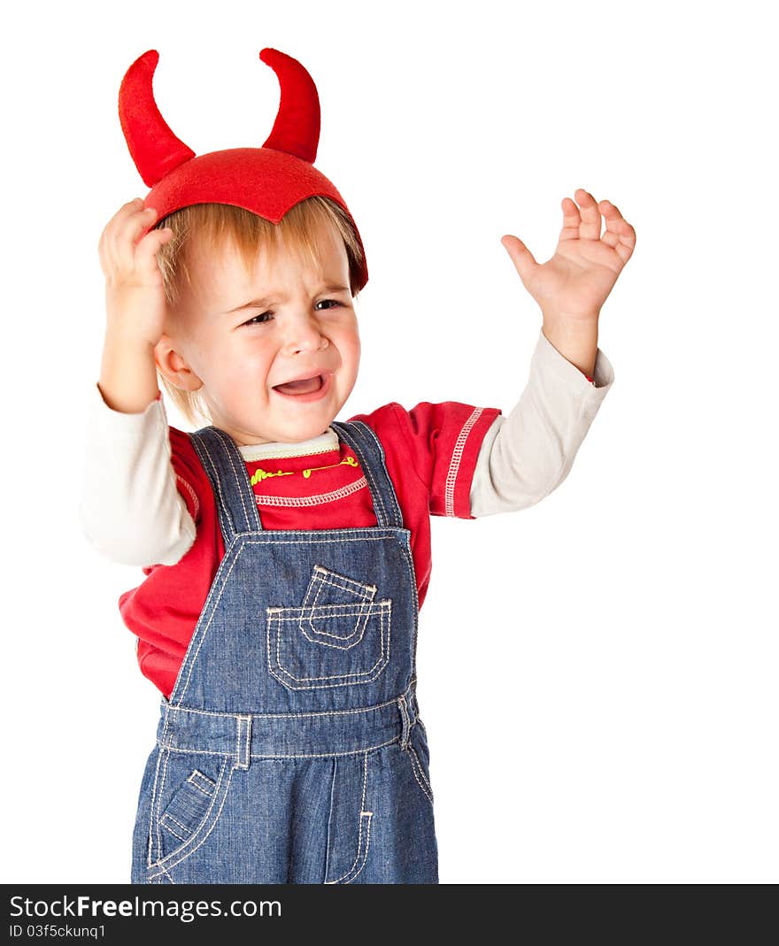 A crying boy in a funny hat. Isolated on a white background