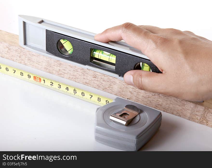 Measuring wood using tape and spirit level bubbles. Measuring wood using tape and spirit level bubbles