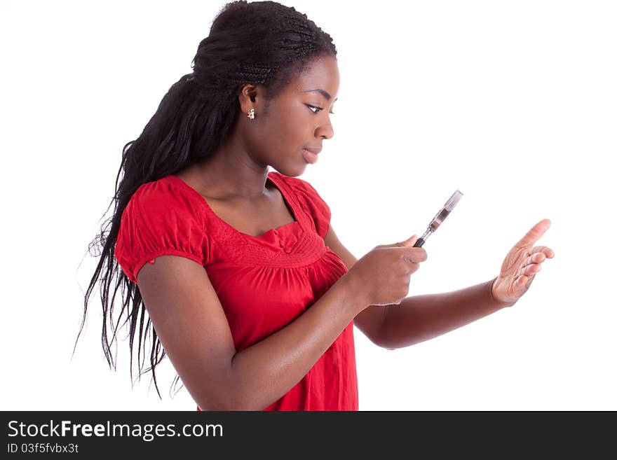 A young black woman is examining her hand with a magnifier. A young black woman is examining her hand with a magnifier