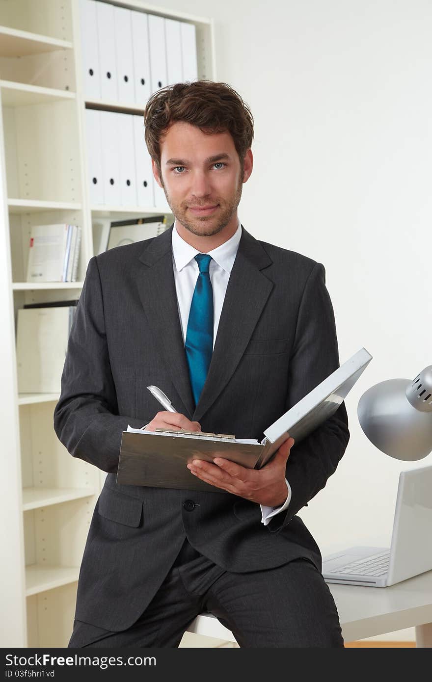 Business man in office with clipboard. Business man in office with clipboard