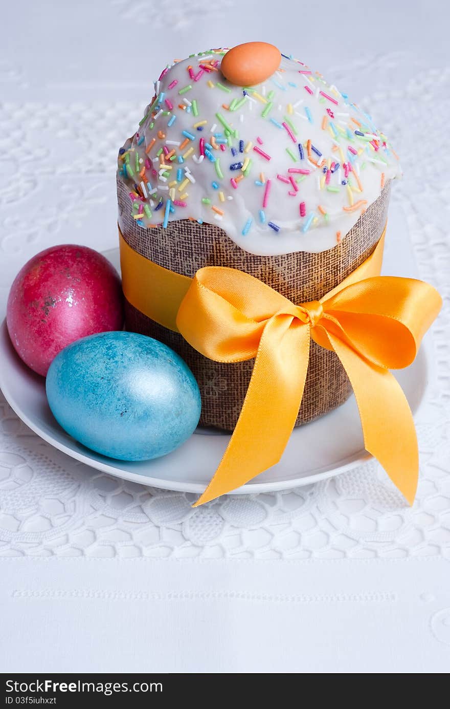 Easter cake and easter eggs on white linen tablecloth, selective focus. Easter cake and easter eggs on white linen tablecloth, selective focus.