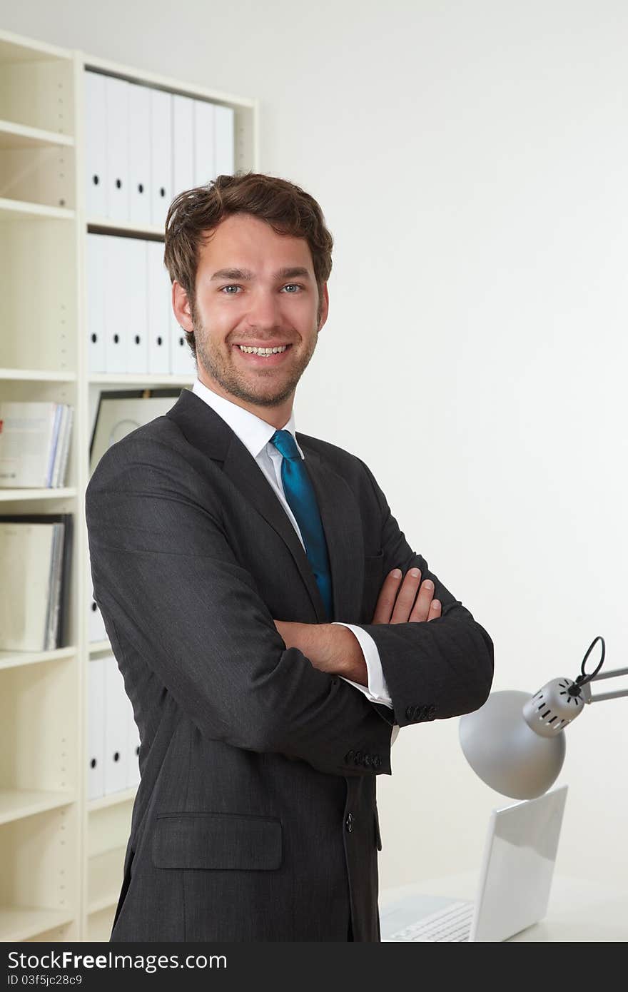 Businessman in office with laptop. Businessman in office with laptop