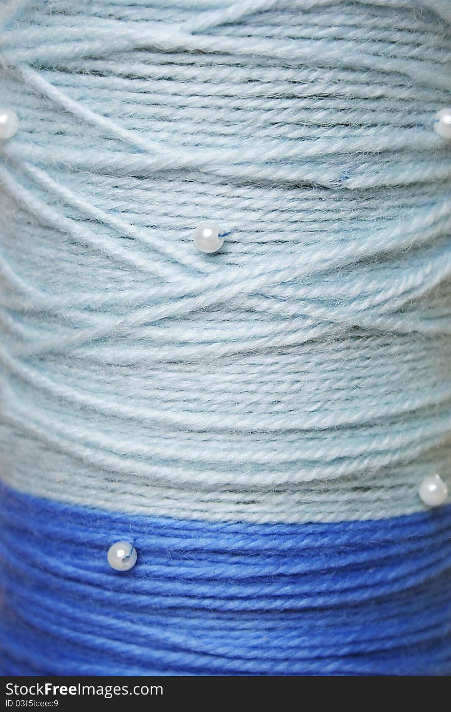 Round texture of blue woolen threads with beads
