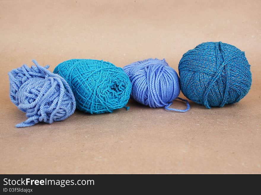 Four blue clews on brown paper background