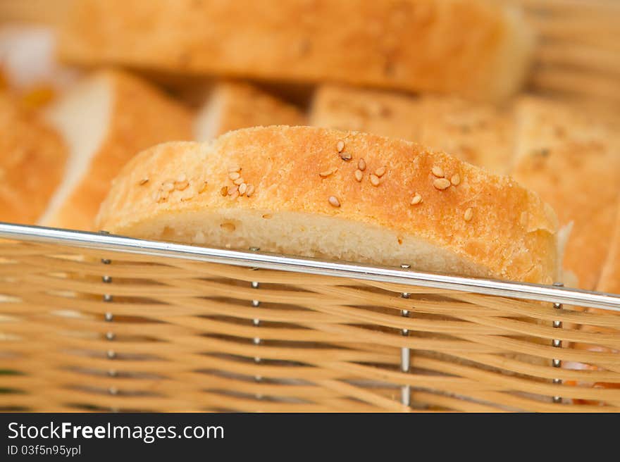 Slices of home made bread with sesame seeds in the basket. Slices of home made bread with sesame seeds in the basket