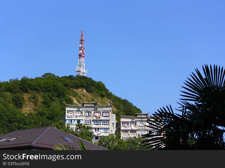 Telecommunication tower and buildings in mountains. The Black Sea coast of Caucasus