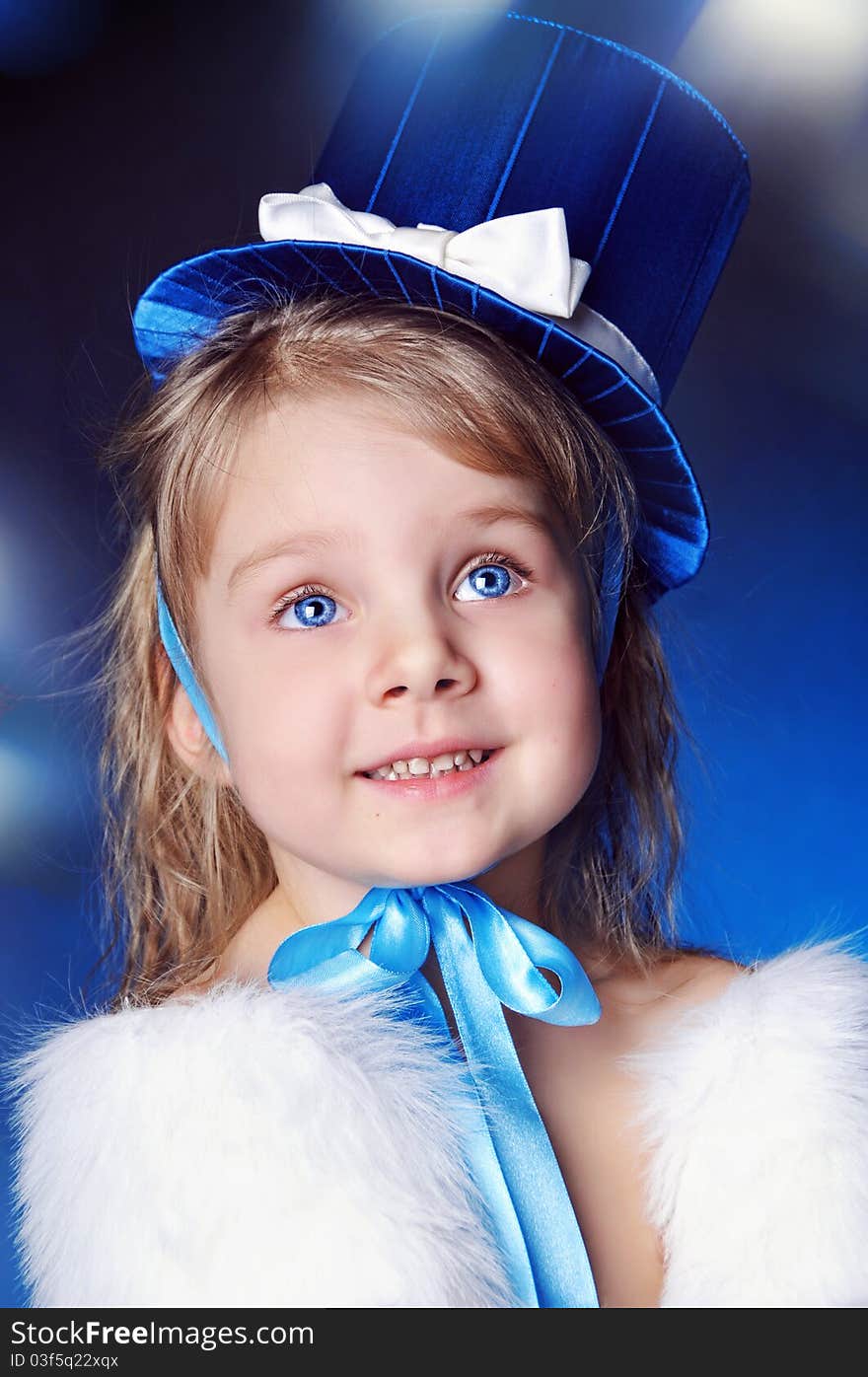 A fairy-tale girl is in dark blue clothes and hat