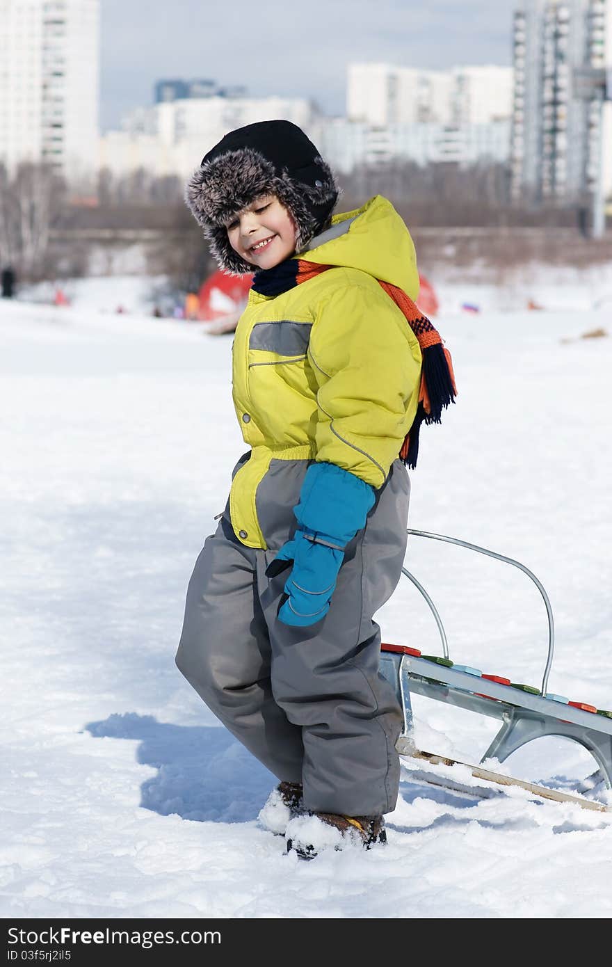 Joyful smiling little boy with sled, winter time. Joyful smiling little boy with sled, winter time