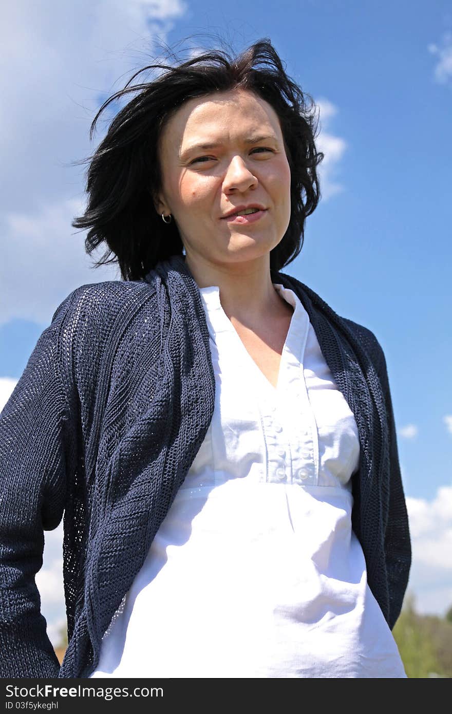 Portrait of a young attractive woman in the blue sky. Portrait of a young attractive woman in the blue sky