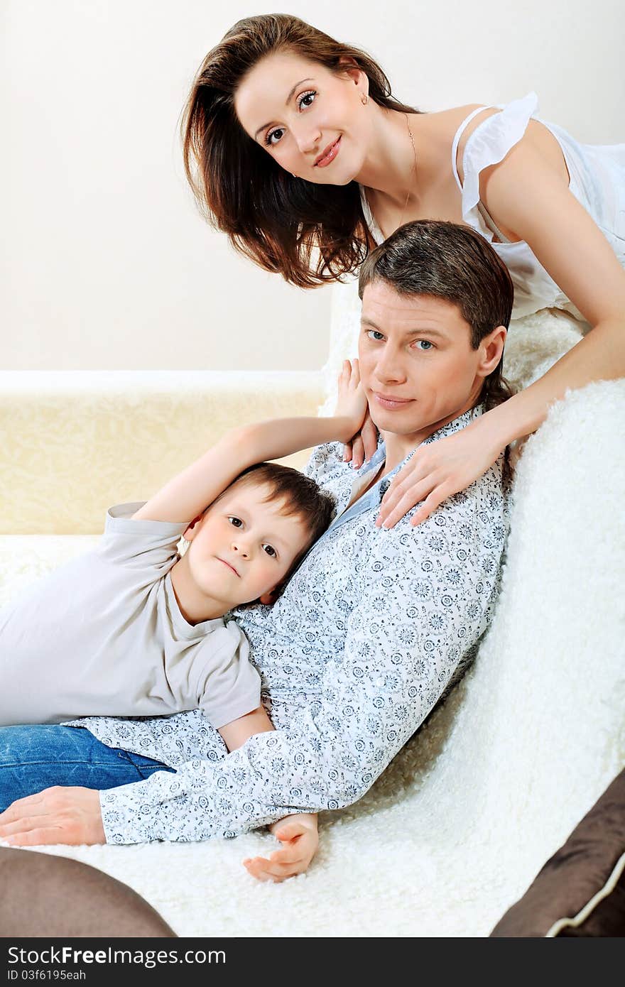 Happy parents with their son at home.