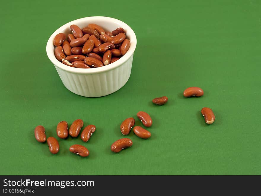 Pot red beans white on green background