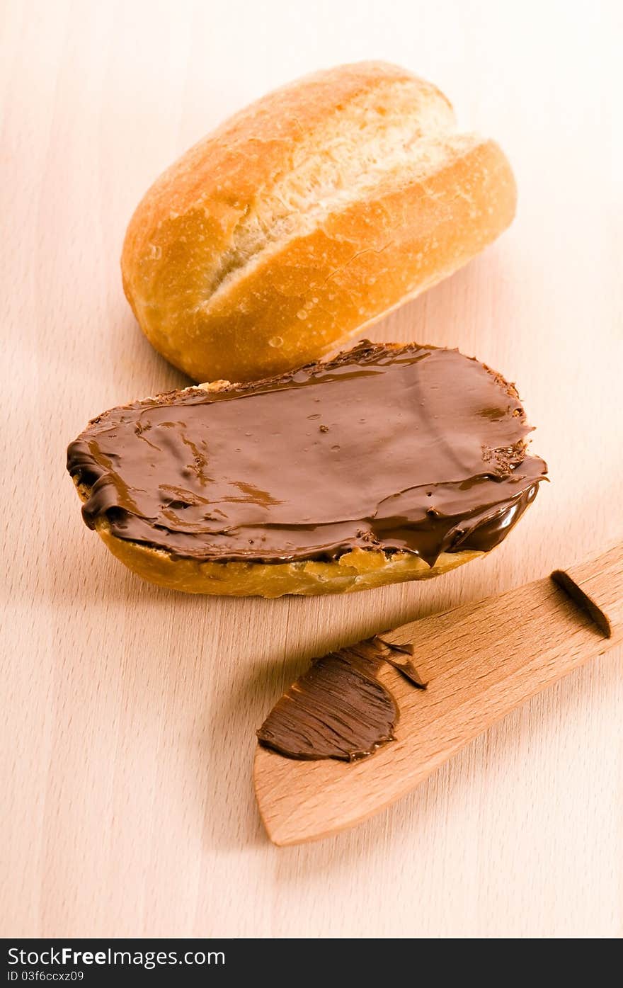 Bread with chocolate cream on the wooden board