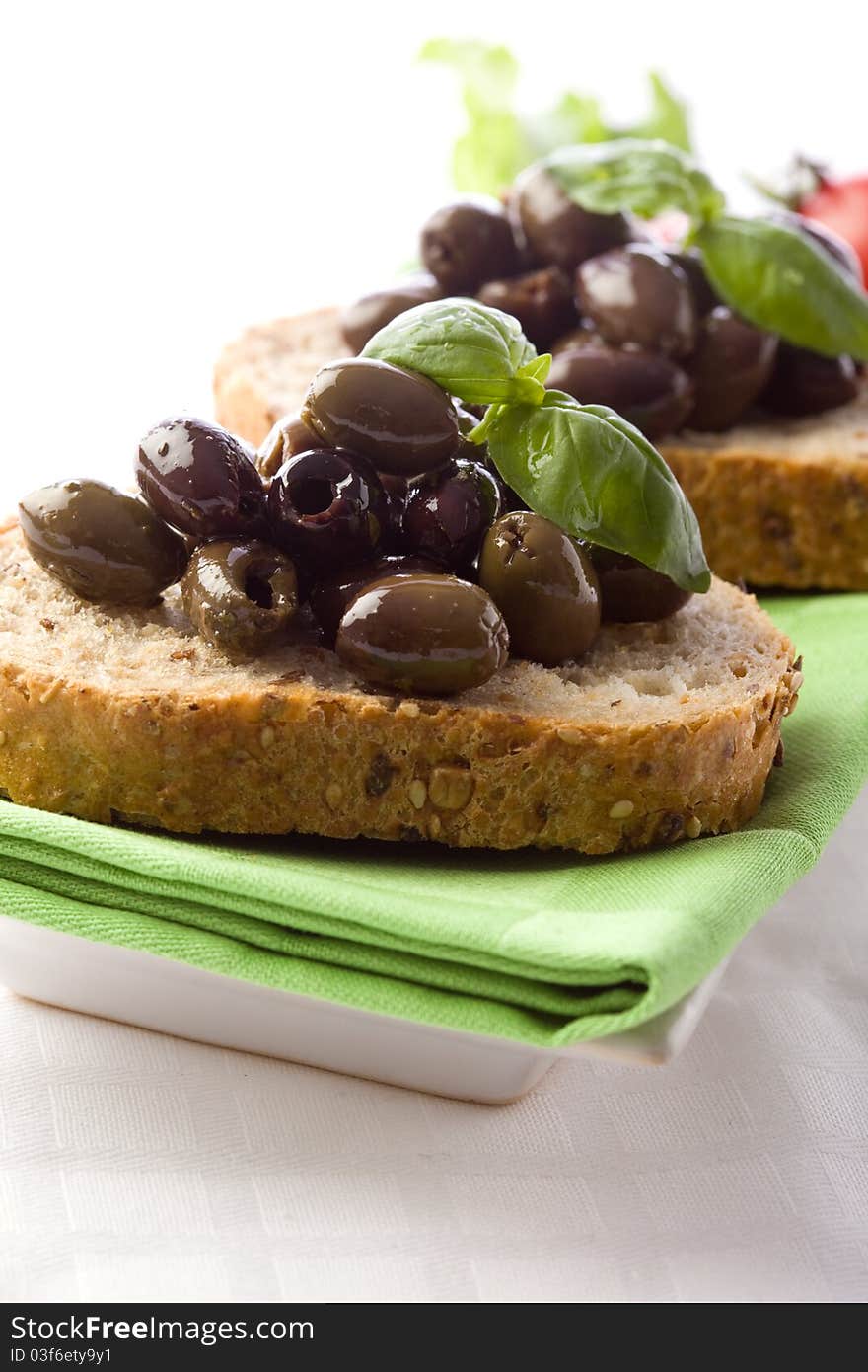 Photo of delicious sliced bread with olives and basil. Photo of delicious sliced bread with olives and basil