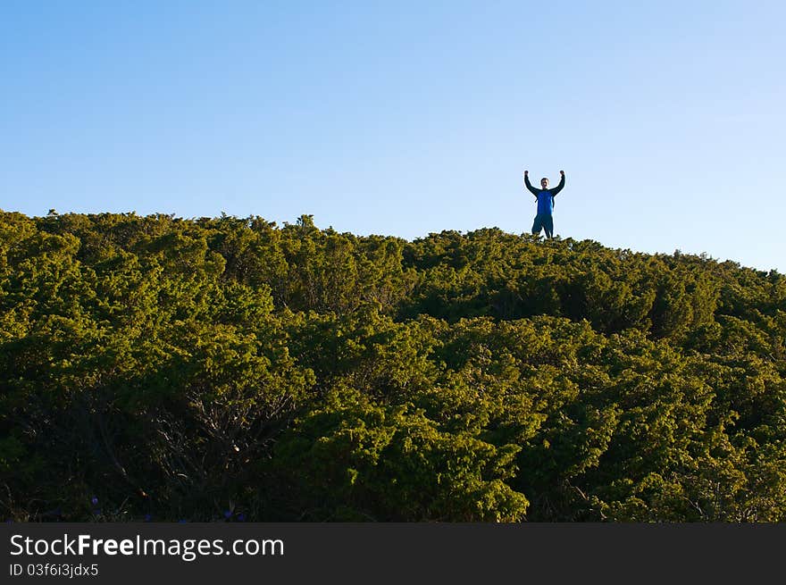 Man with open hands in the air enjoying expedition. Man with open hands in the air enjoying expedition.