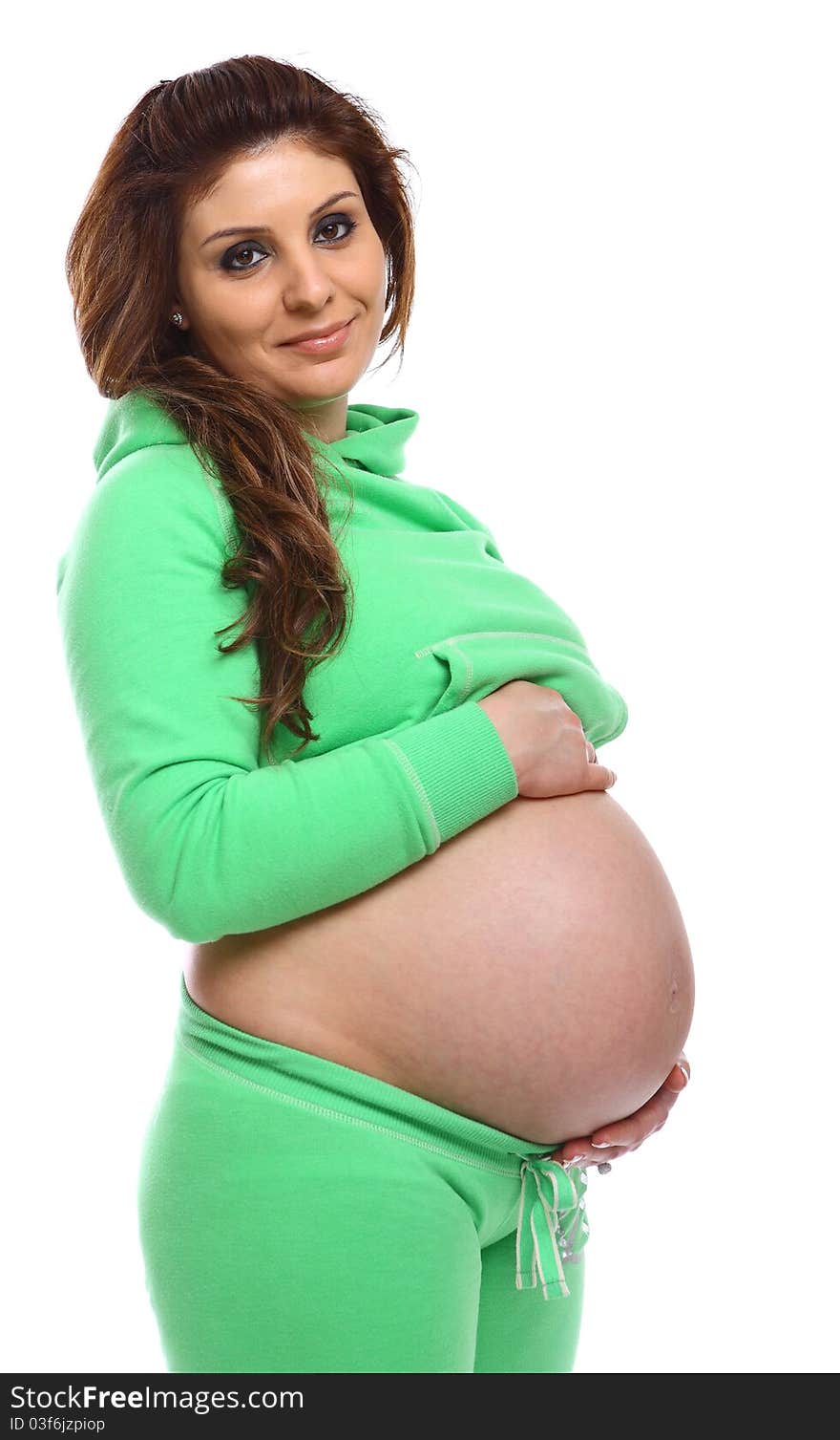 Smiling pregnant woman holding her baby isolated on white