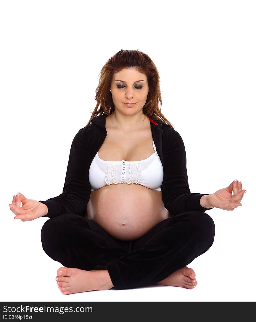 Pregnant woman meditating, with her bare tummy out, isolated on white. Pregnant woman meditating, with her bare tummy out, isolated on white