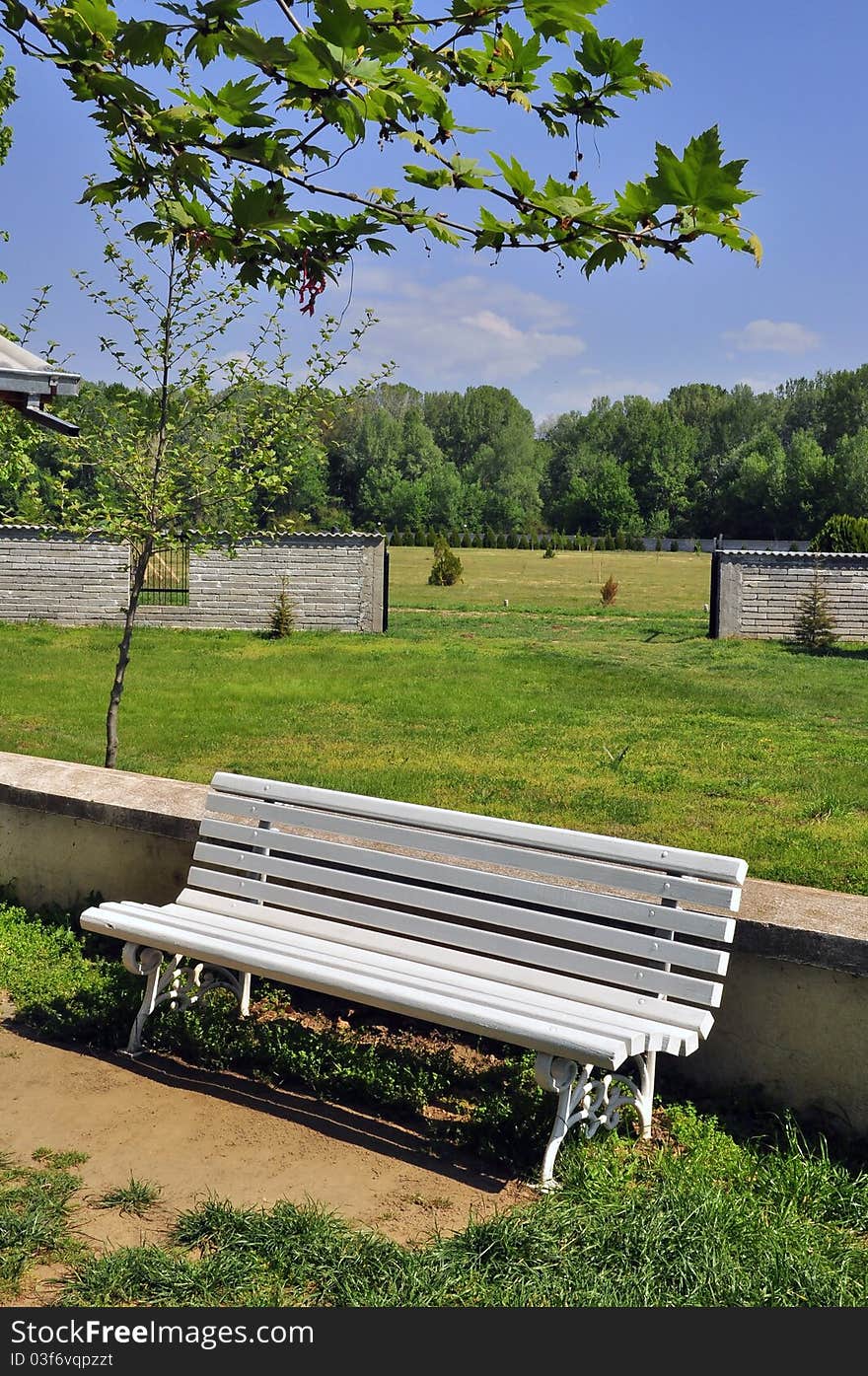 White bench in a green park